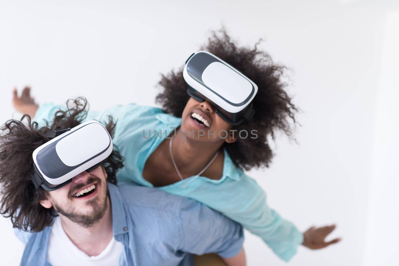 multiethnic couple getting experience using VR headset glasses by dotshock