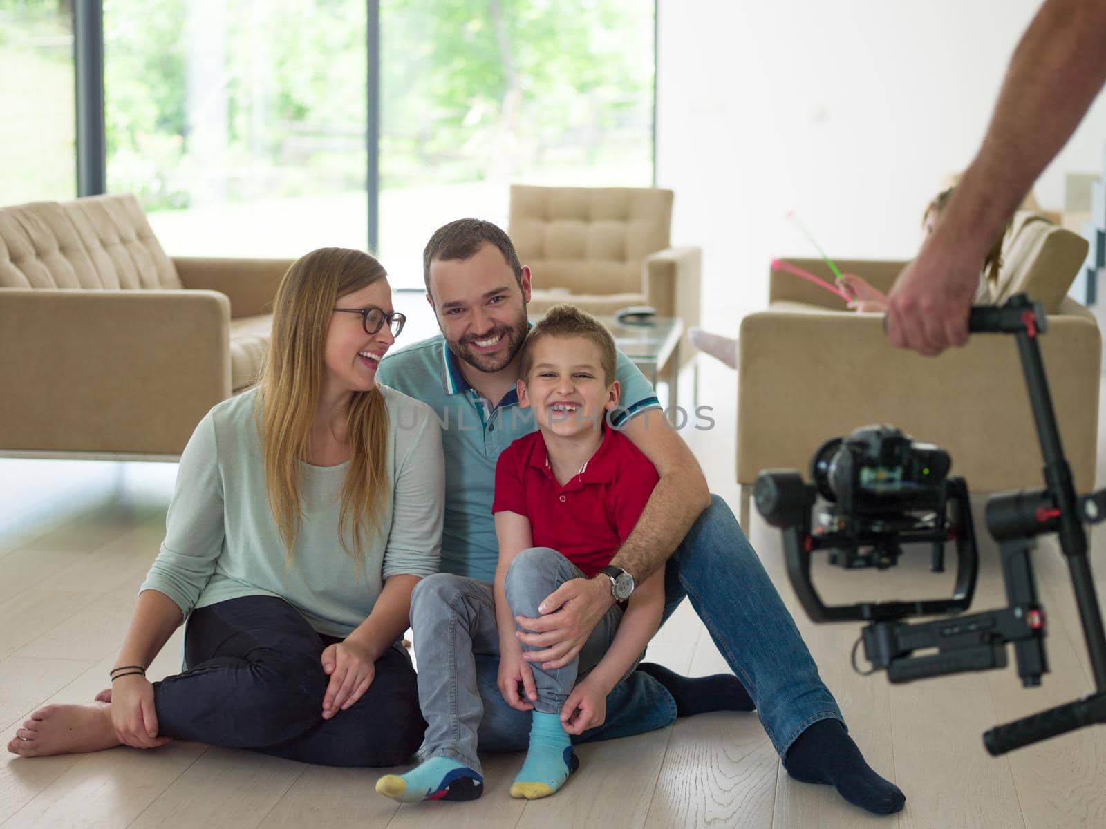 happy young family with little boy enjoys in the modern living room of their luxury home villa