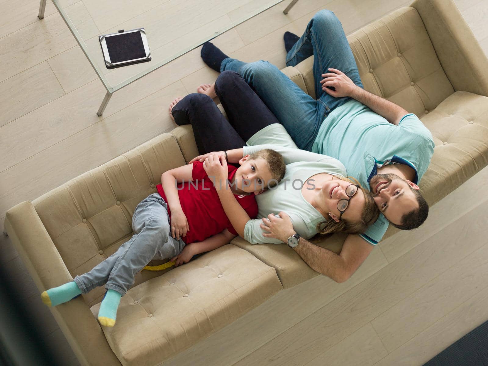 happy young family with little boy enjoys in the modern living room of their luxury home villa