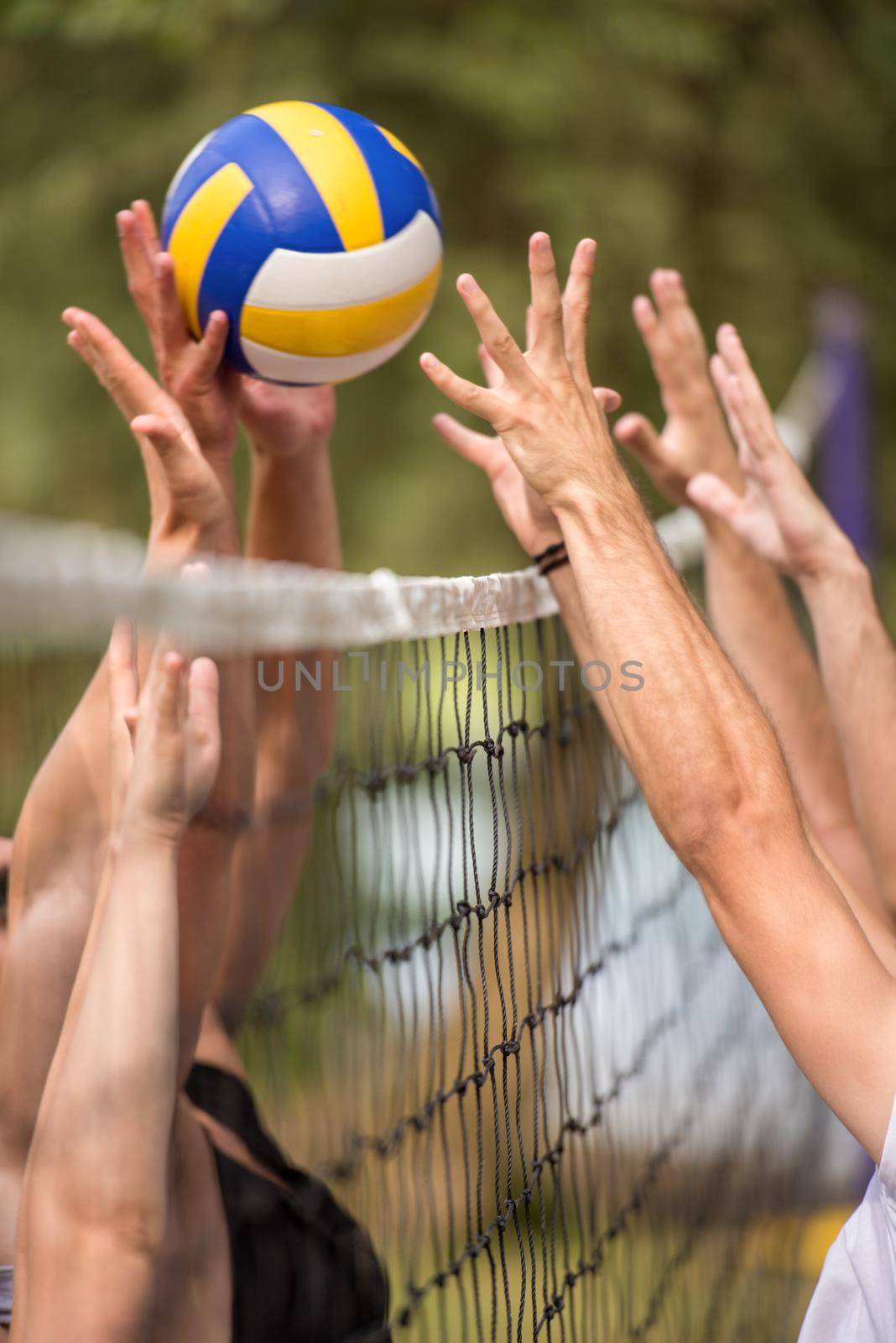 group of young friends playing Beach volleyball by dotshock