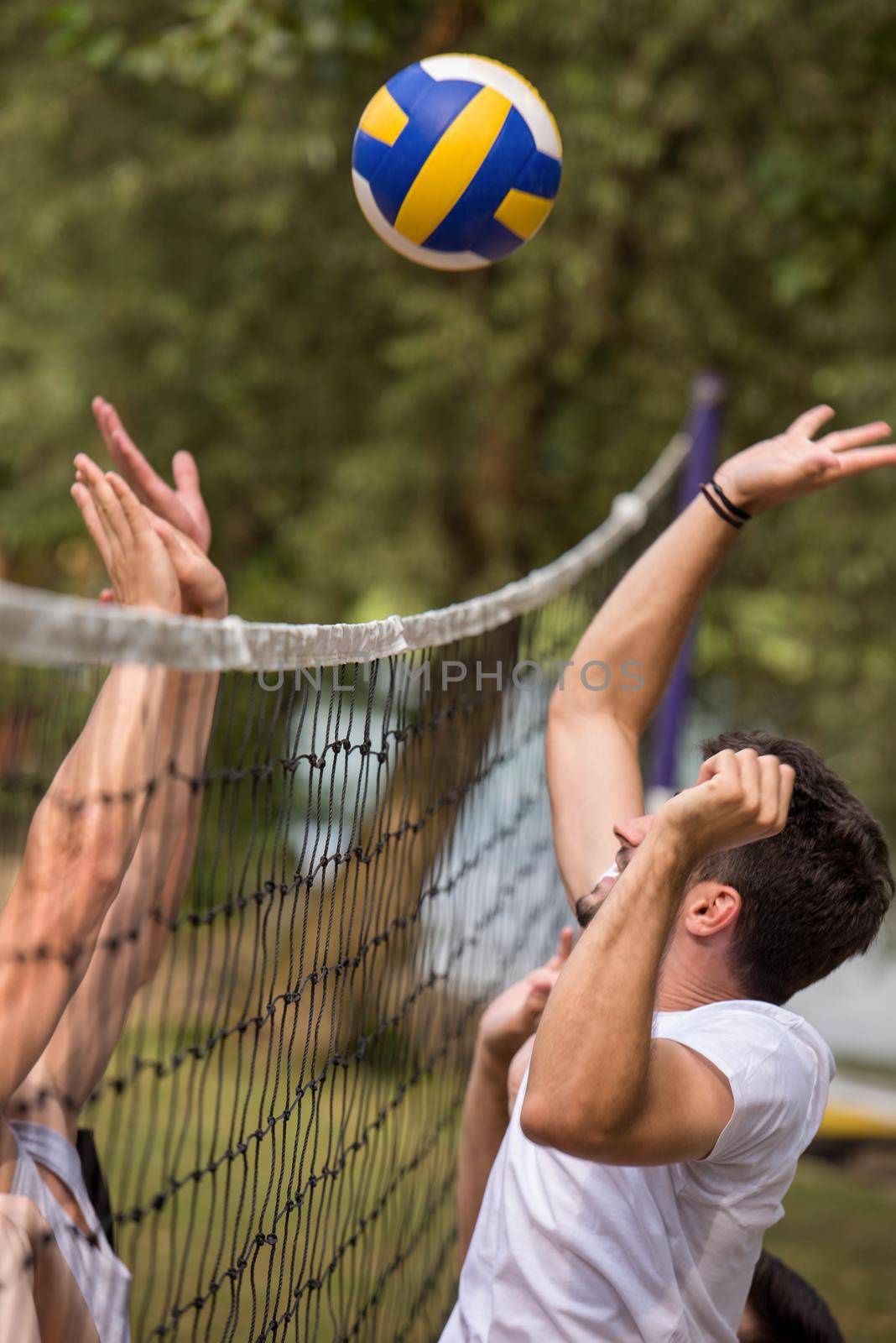 group of young friends playing Beach volleyball by dotshock