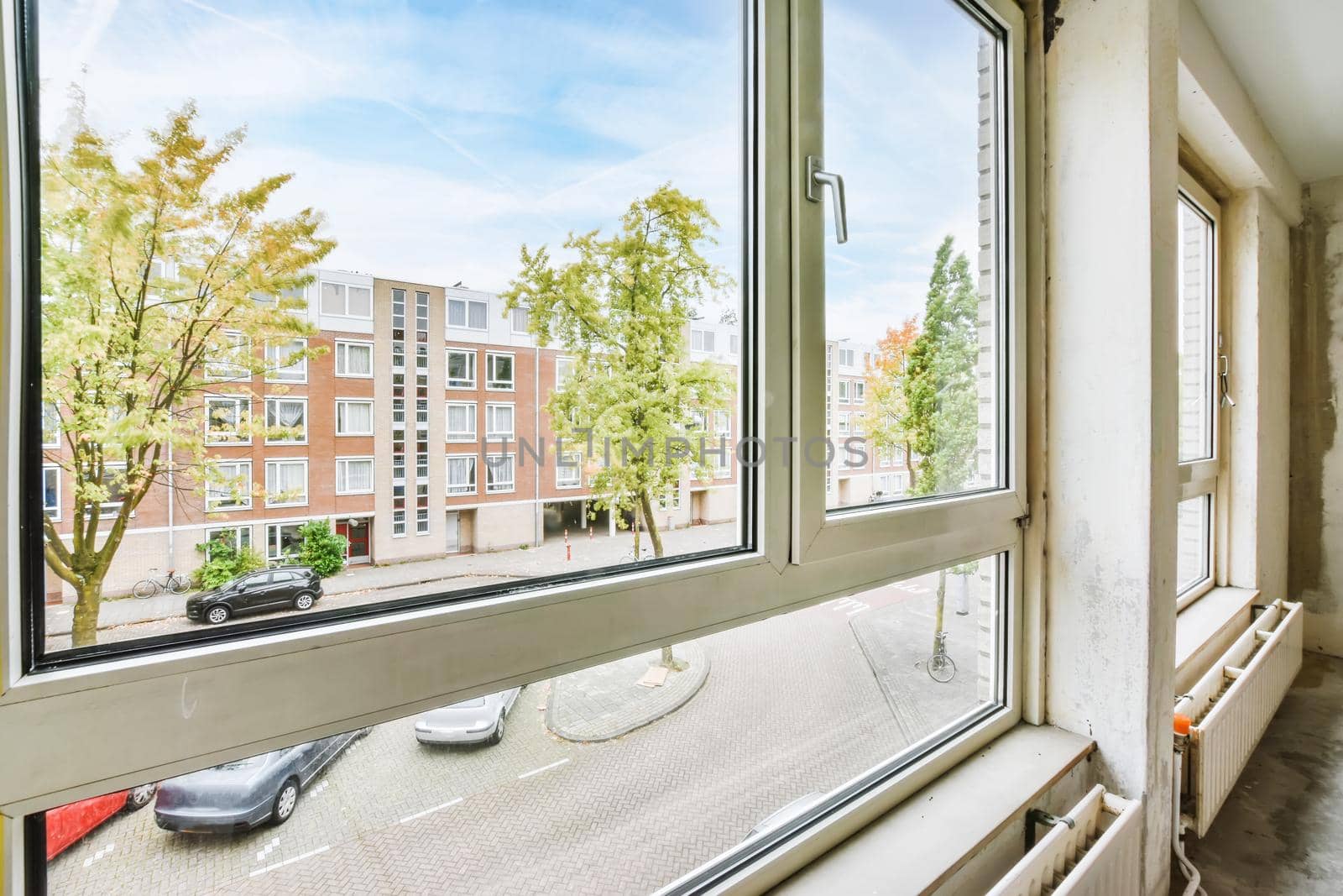 Pretty view from the window to a street with trees