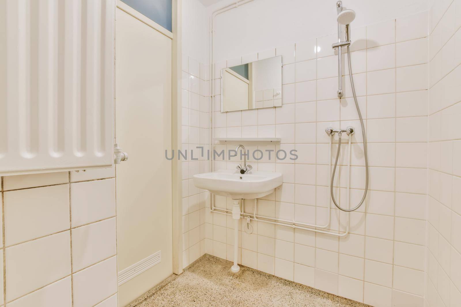 Bathroom with shower and washbasin with white tiles