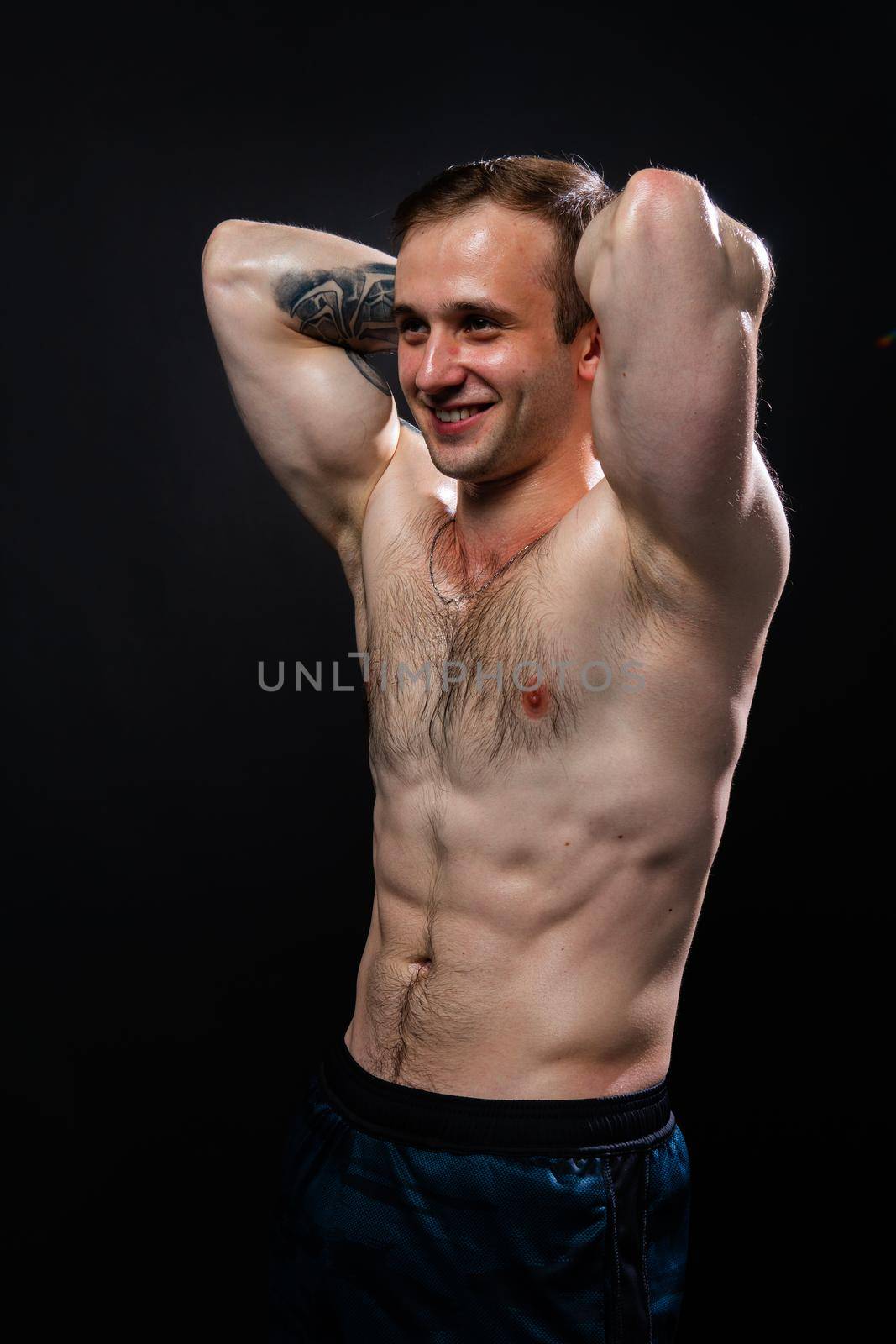 Man on black background keeps dumbbells pumped up in fitness muscle chest black, athlete fitness hold hand, person pectoral. handsome adult, one fit hands behind your head a beautiful press by 89167702191
