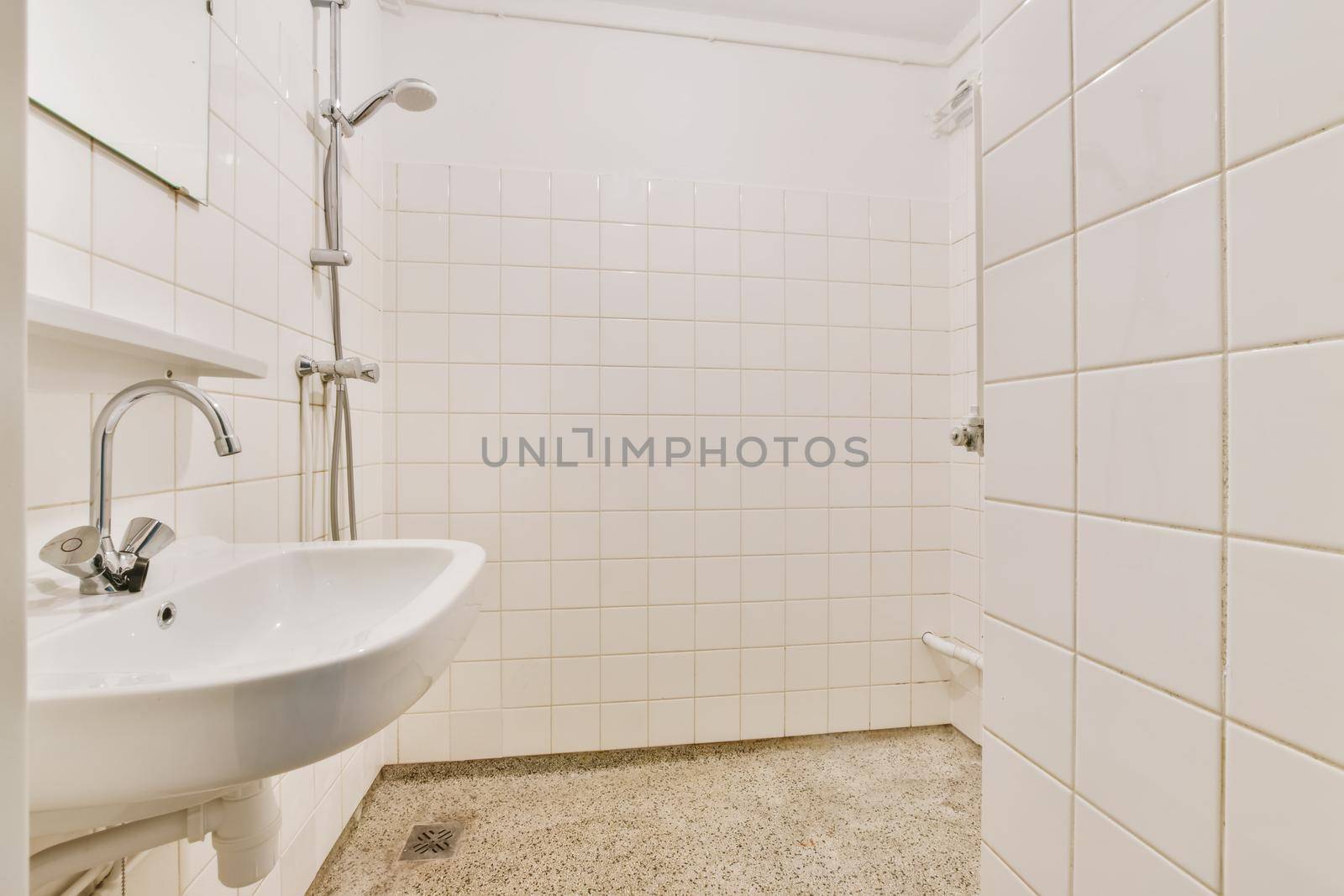 Bathroom with shower and washbasin with white tiles