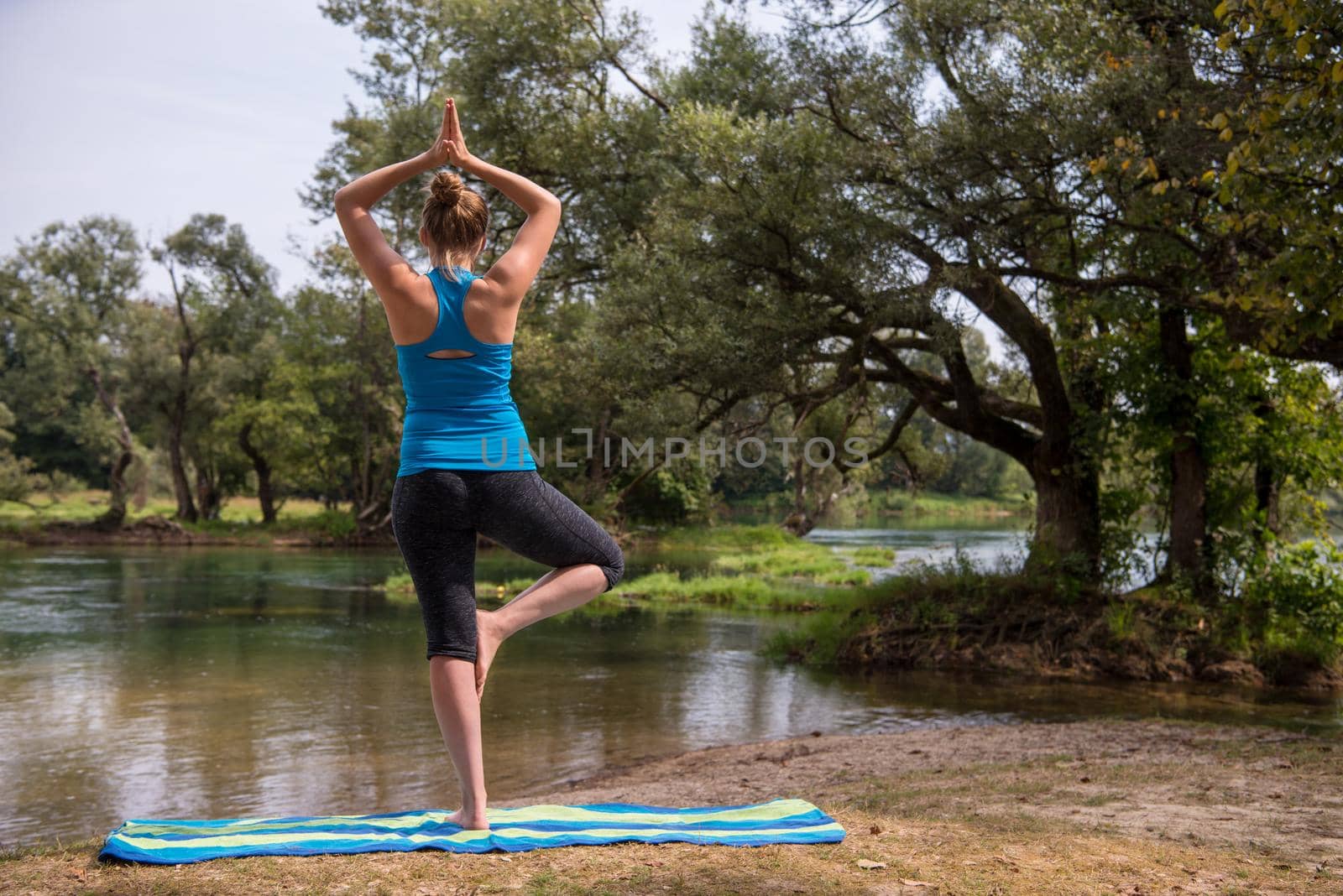 woman meditating and doing yoga exercise by dotshock