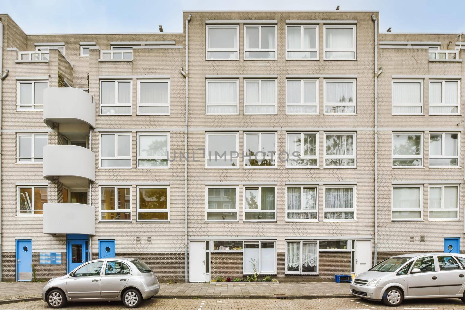 Beautiful view of a residential building with parking
