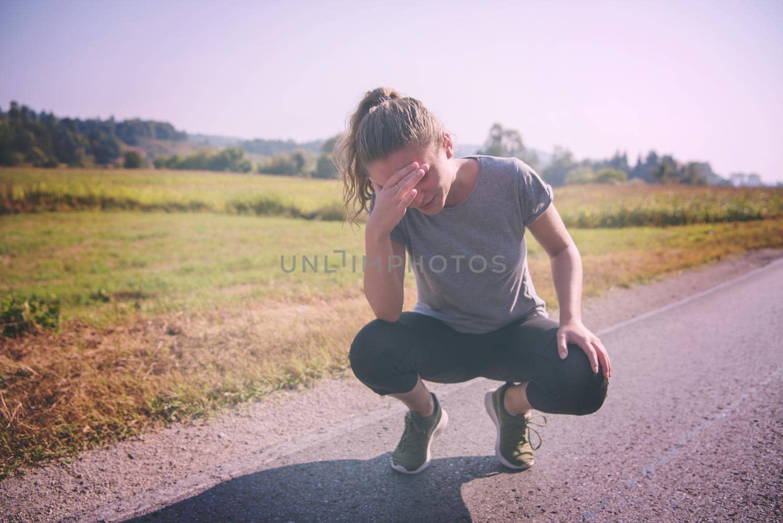 woman jogging along a country road by dotshock