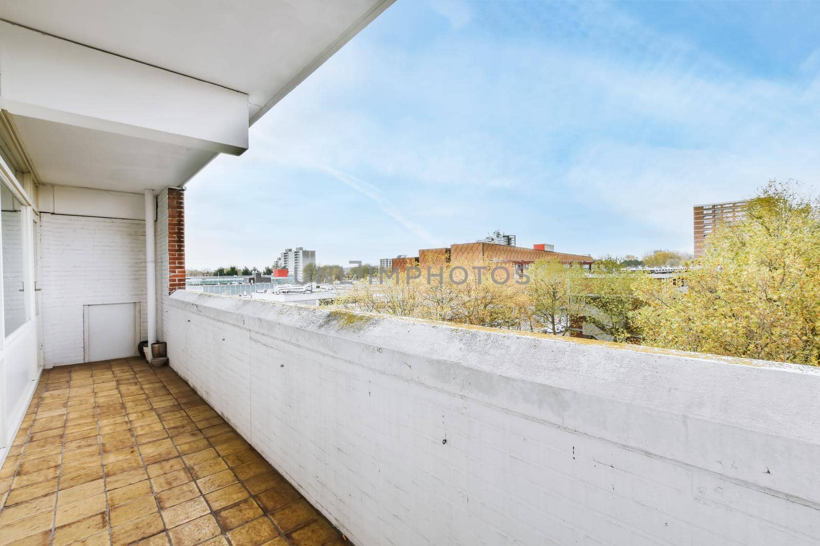Long narrow balcony with tiled floor and brick handrails
