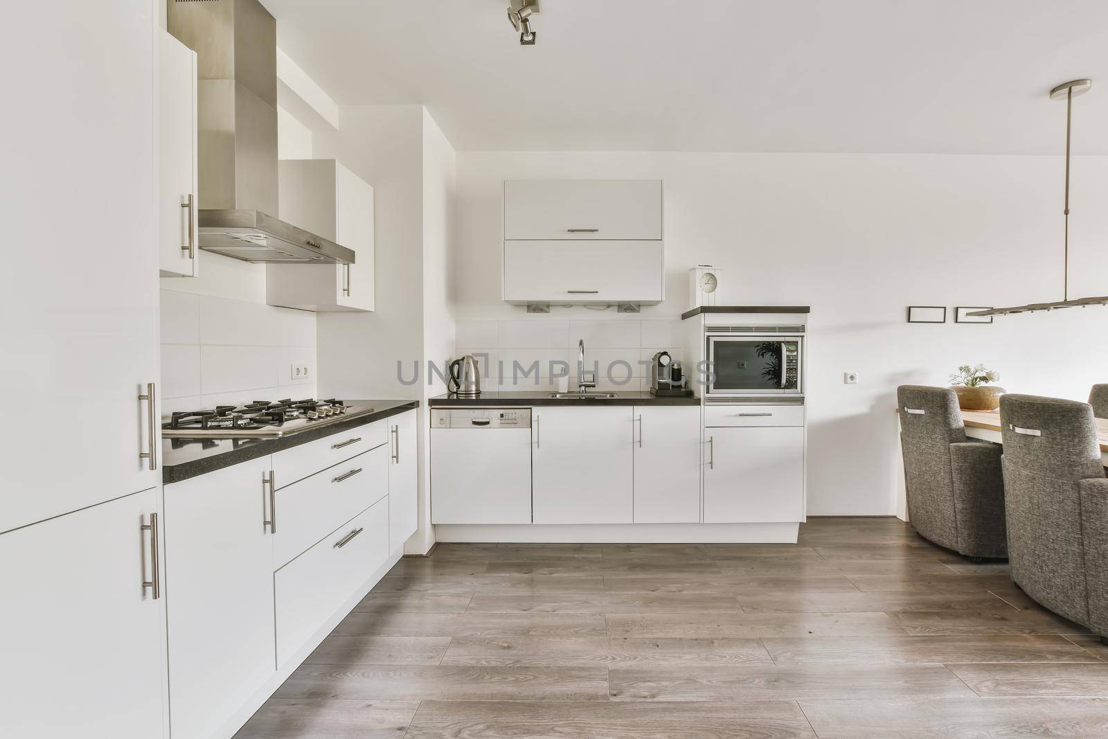 Modern kitchen with white kitchen unit and gray parquet floor