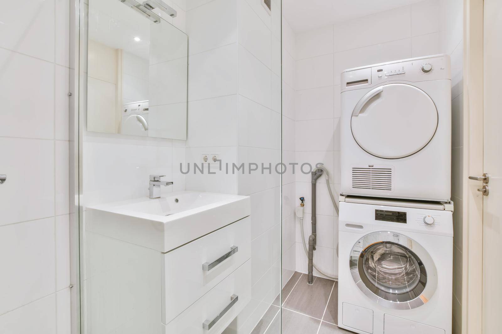Bright bathroom with washing machine and tumble dryer