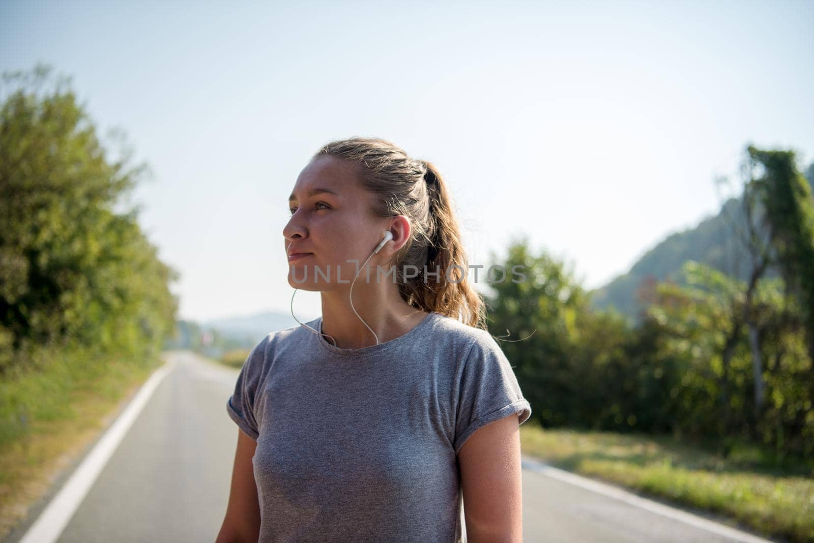 woman jogging along a country road by dotshock