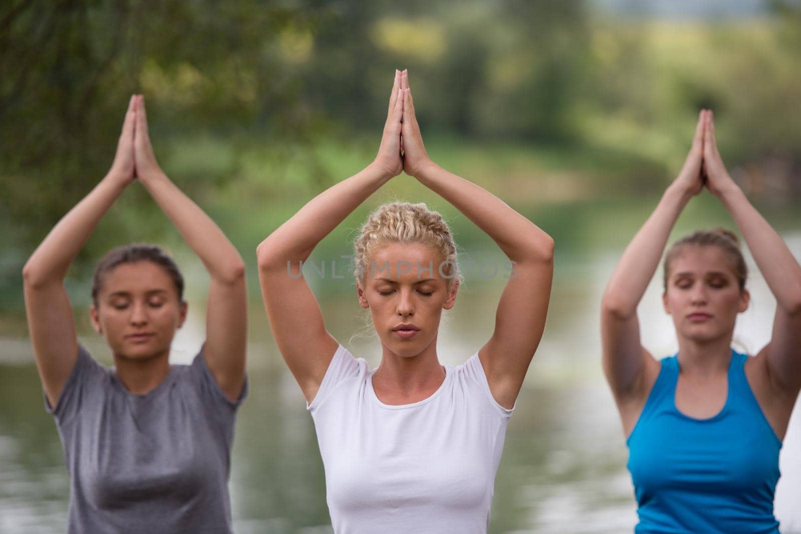 women meditating and doing yoga exercise by dotshock