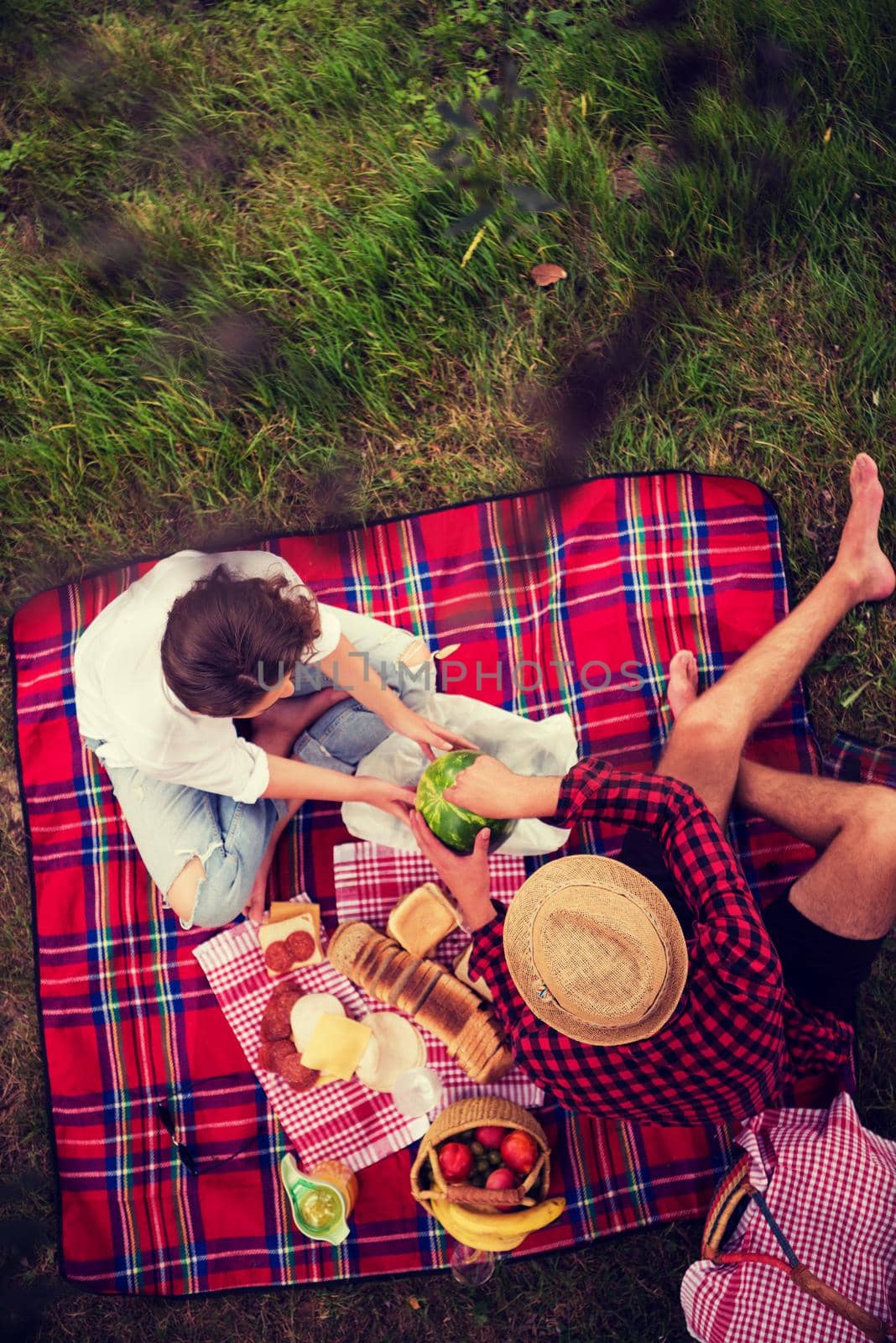 Couple in love enjoying picnic time drink and food in beautiful nature on the river bank top view