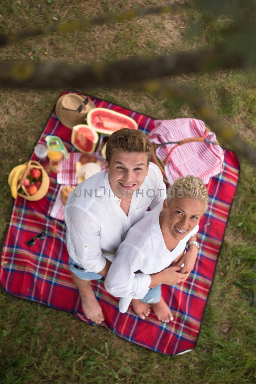 Couple in love enjoying picnic time drink and food in beautiful nature on the river bank top view