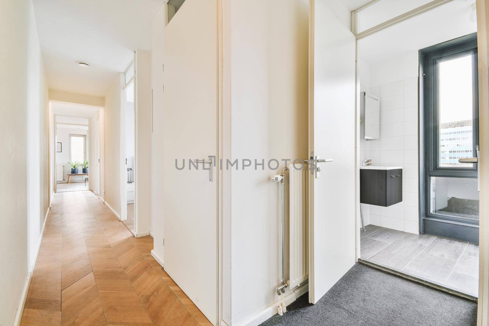 Interior of contemporary flat in minimal style with spacious hallway with white walls