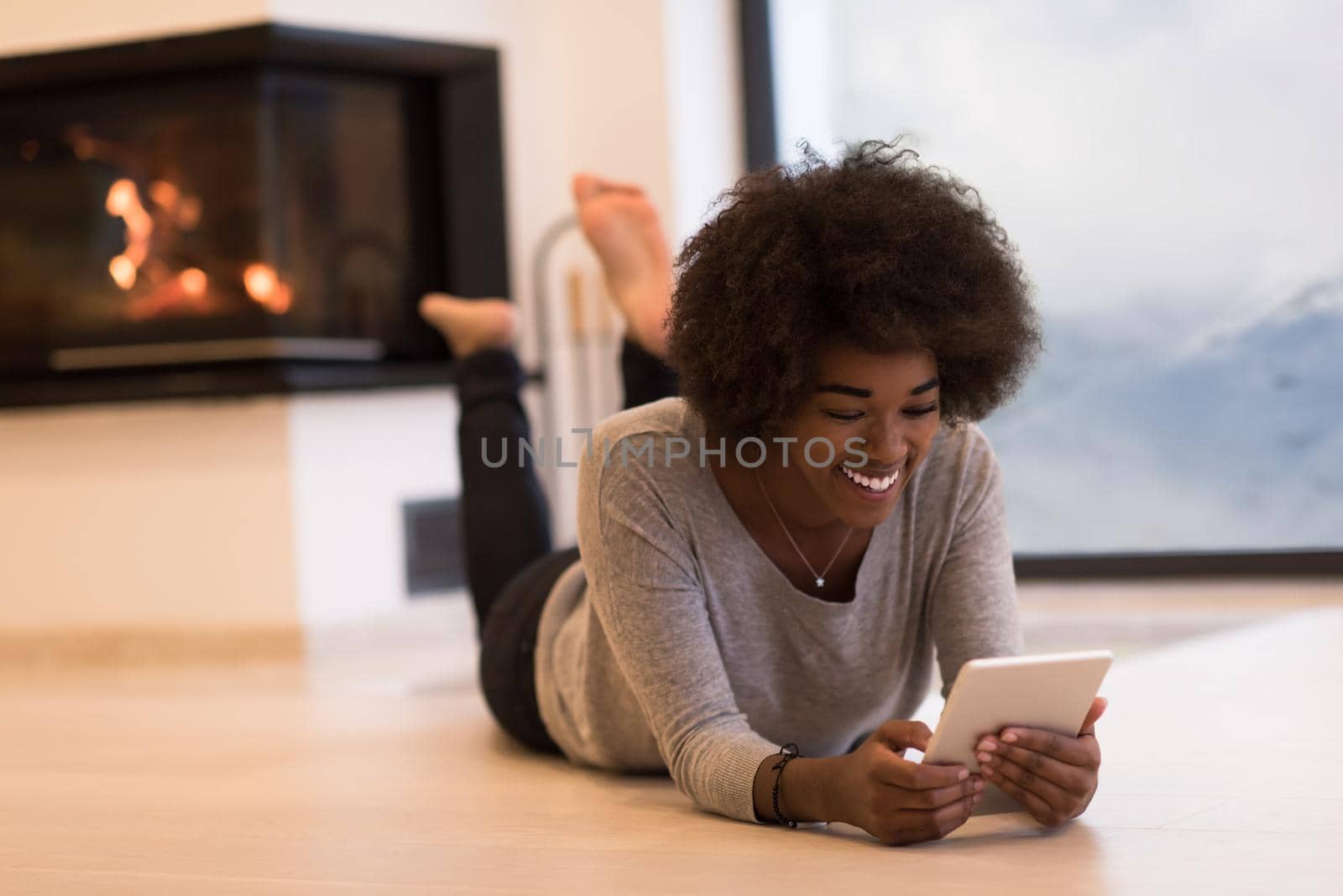 black women using tablet computer on the floor by dotshock