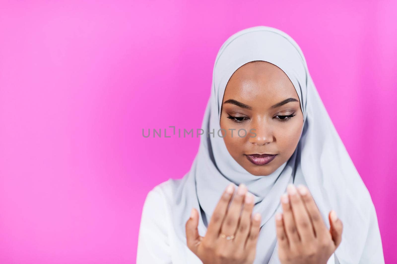African Muslim woman makes traditional prayer to God by dotshock