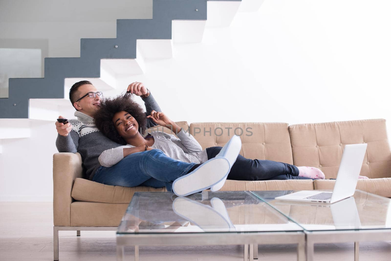 multiethnic couple relaxing at home by dotshock