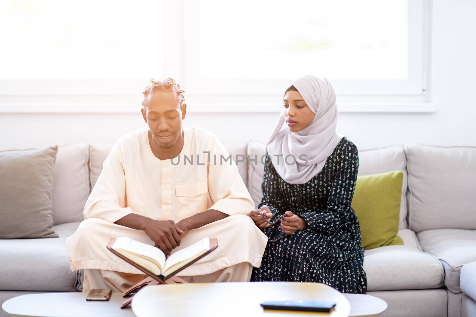 african muslim couple at home in ramadan reading quran holly islam book
