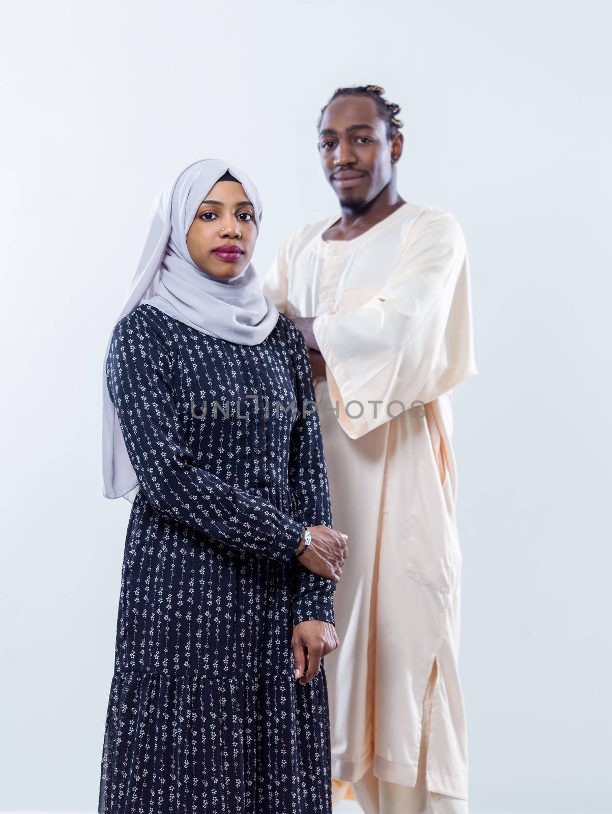portrait of young african modern muslim couple wearing traditional clothes isolated on white background