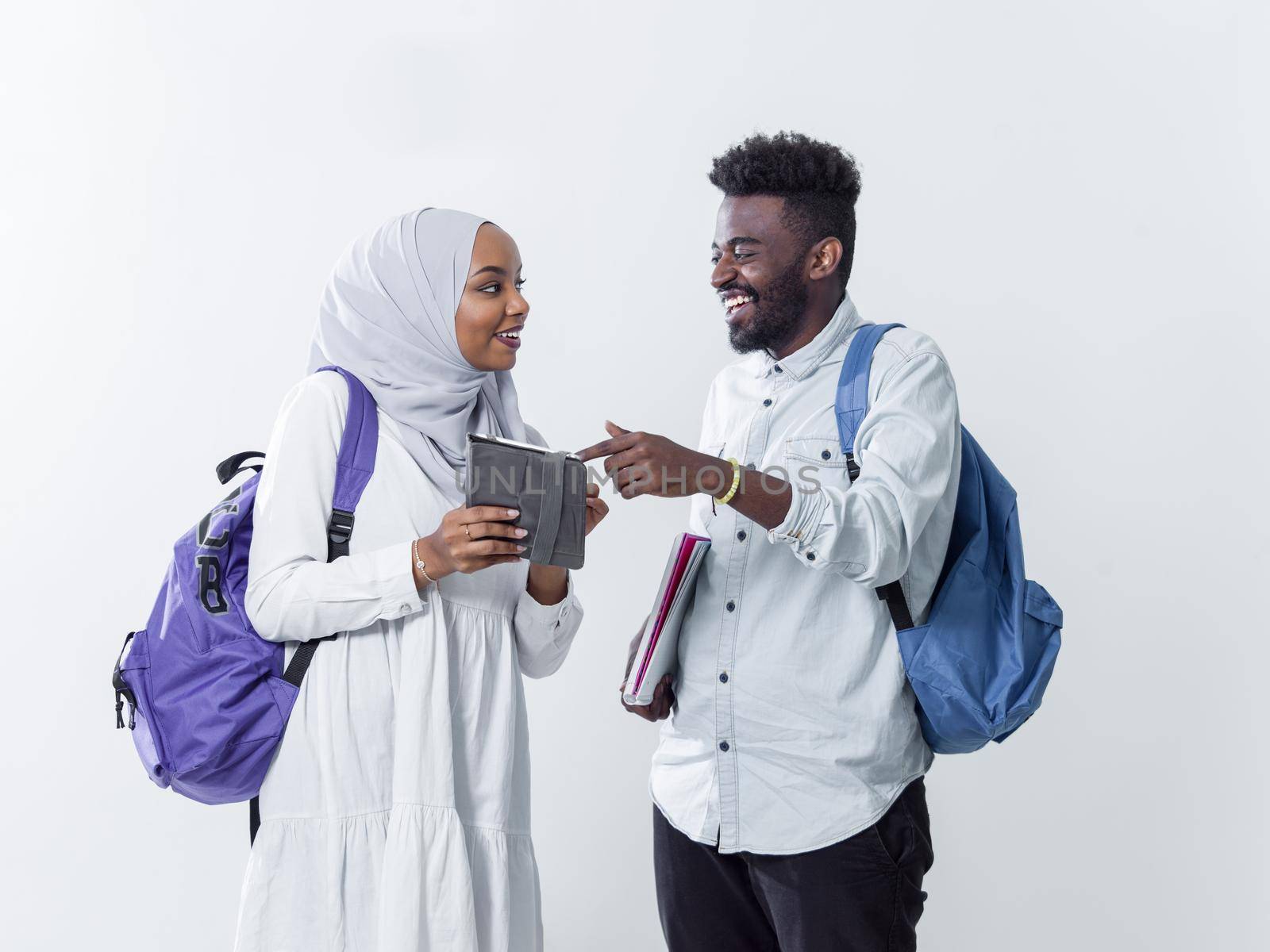 portrait of happy african students standing together against white background girl wearing traidiional sudan muslim hijab fashion