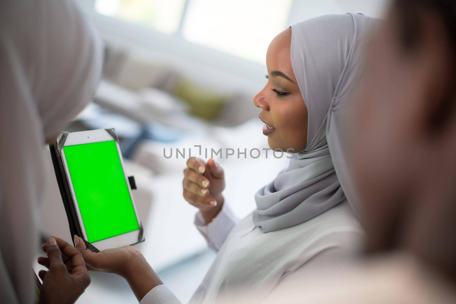 group of happy african students having conversation and team meeting working together on homework girls wearing traidiional sudan muslim hijab fashion