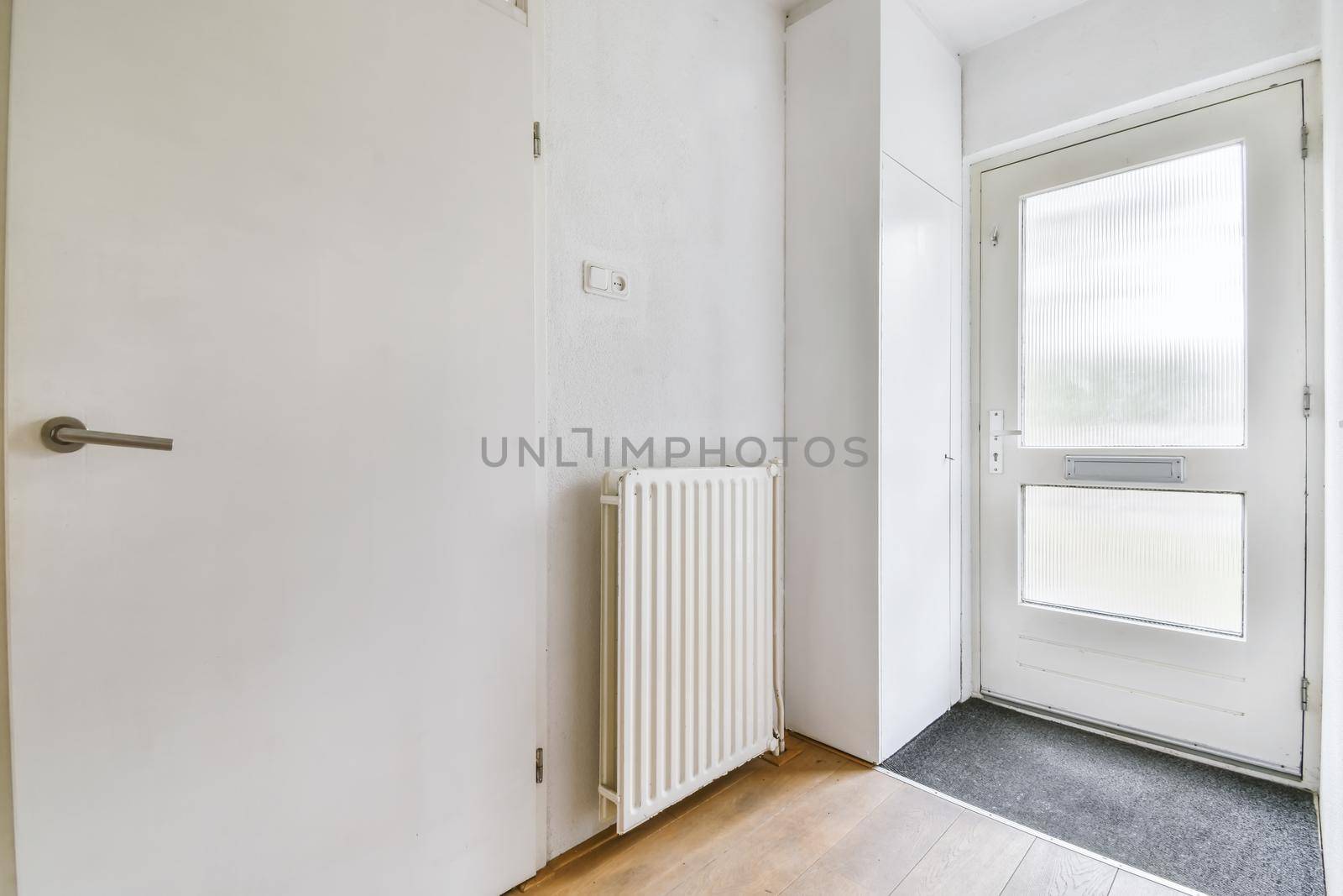 Apartment entrance door with radiator and parquet floor
