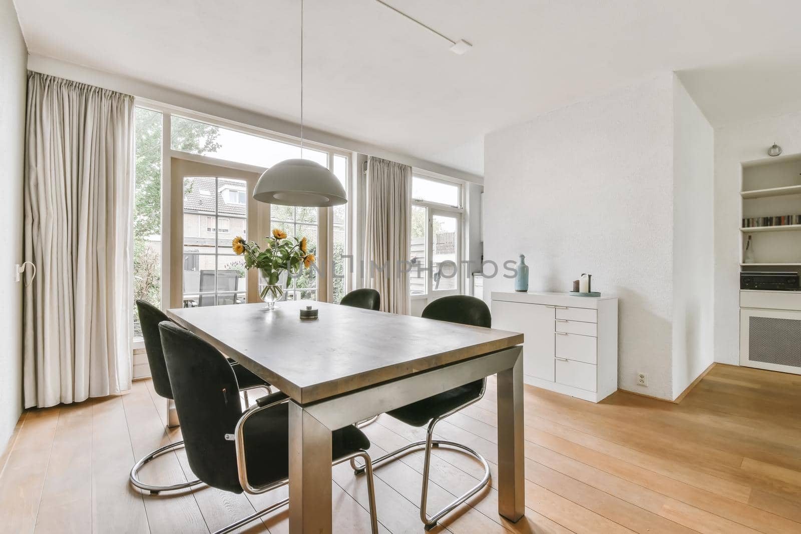 Dining area with stylish table and comfortable soft black chairs