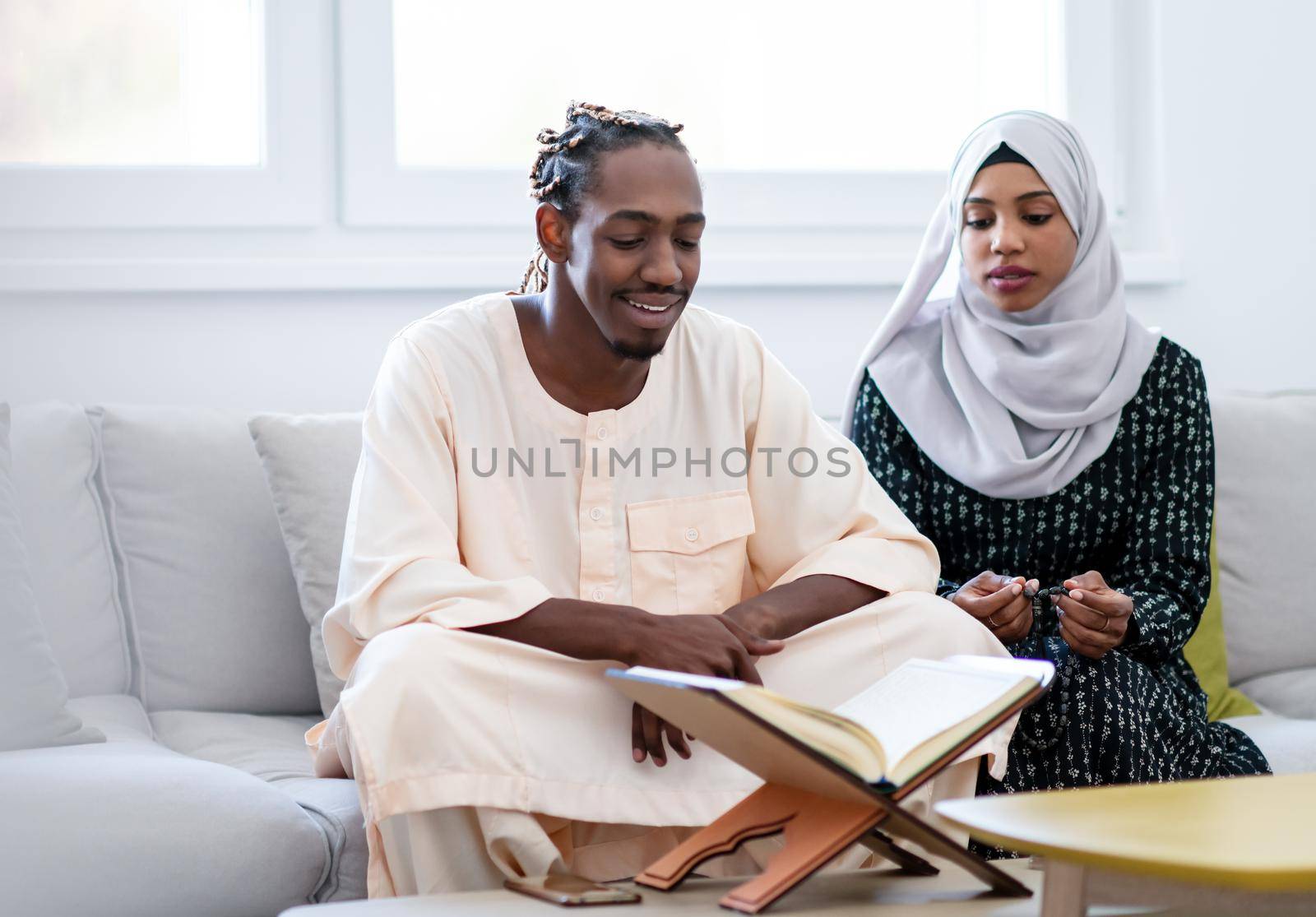 african muslim couple at home in ramadan reading quran holly islam book