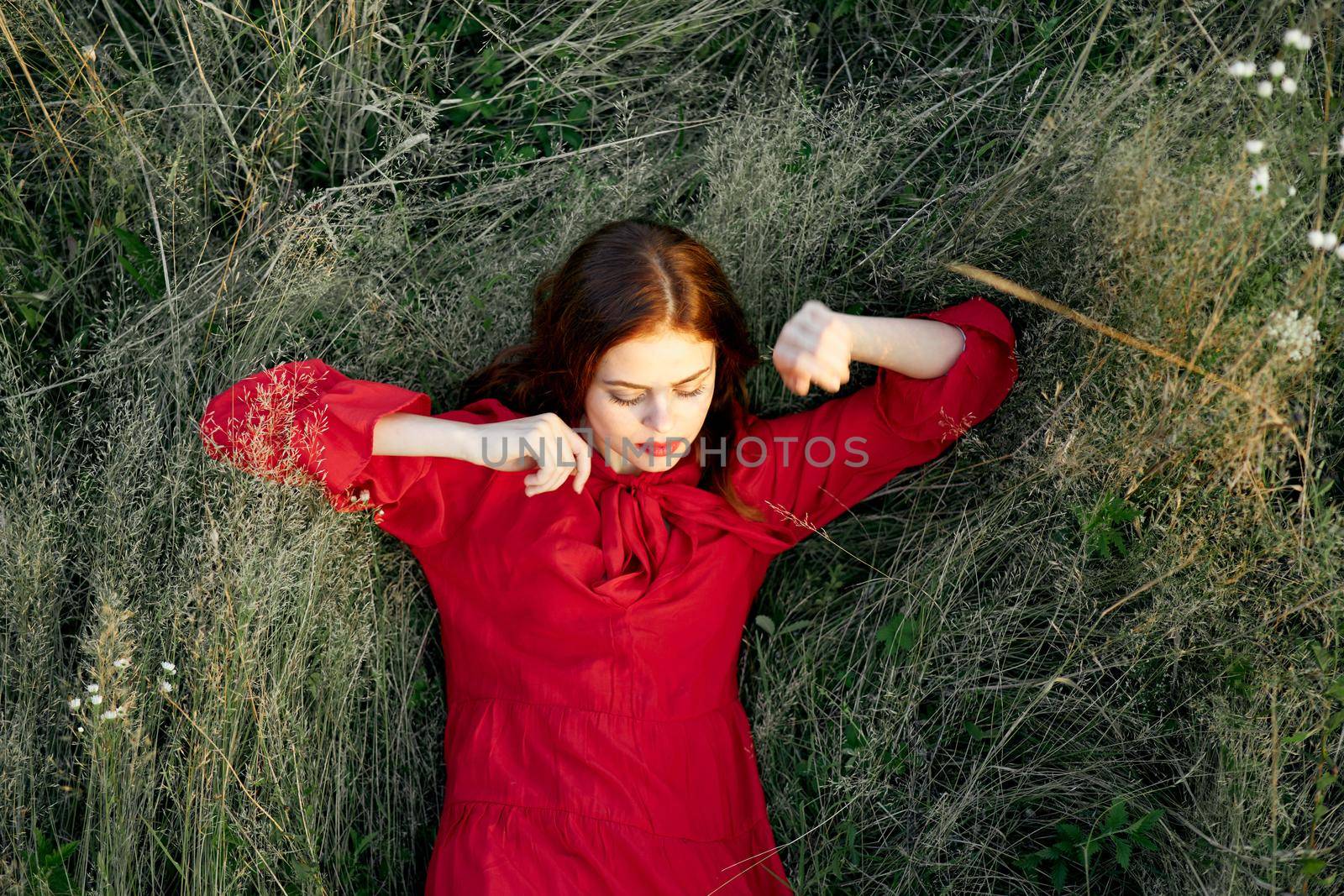 woman in red dress nature green grass landscape rest. High quality photo