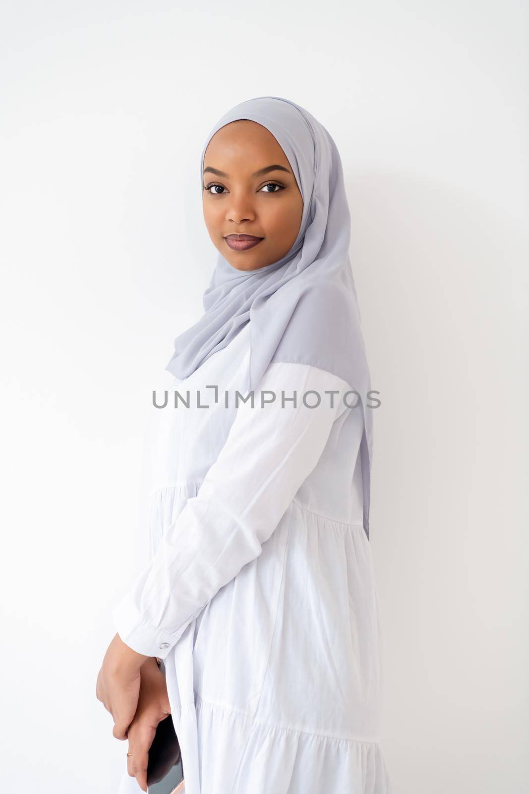 young modern muslim african business woman using smartphone wearing hijab clothes isolated on white background