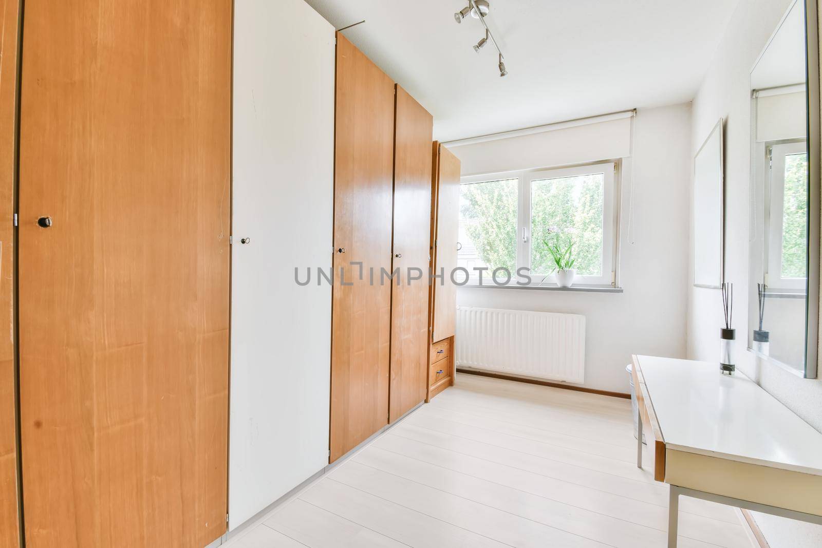 Long room with a full-length wooden wardrobe