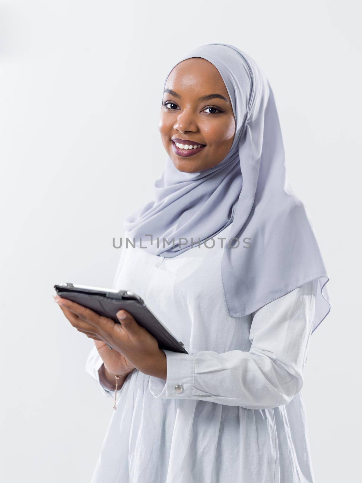 young modern muslim african business woman using tablet computer wearing hijab clothes isolated on white background