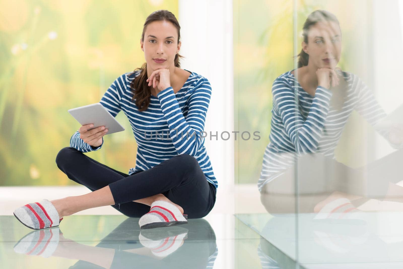 beautiful young women using tablet computer on the floor at home