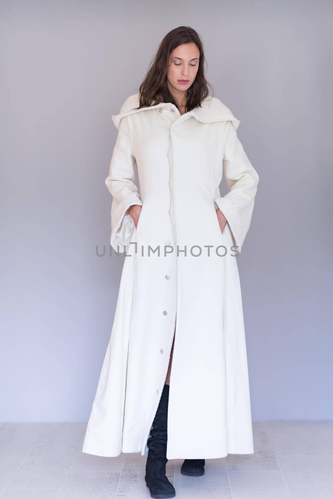 portrait of Beautiful young woman wearing a white coat with hood isolated on white background