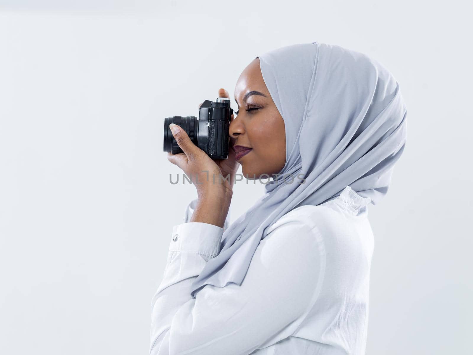 african modern muslim woman using retro camera by dotshock