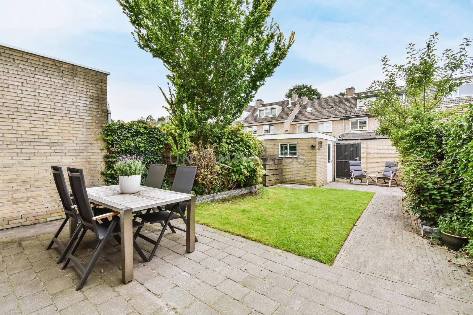 House courtyard with a chic table and comfortable chairs