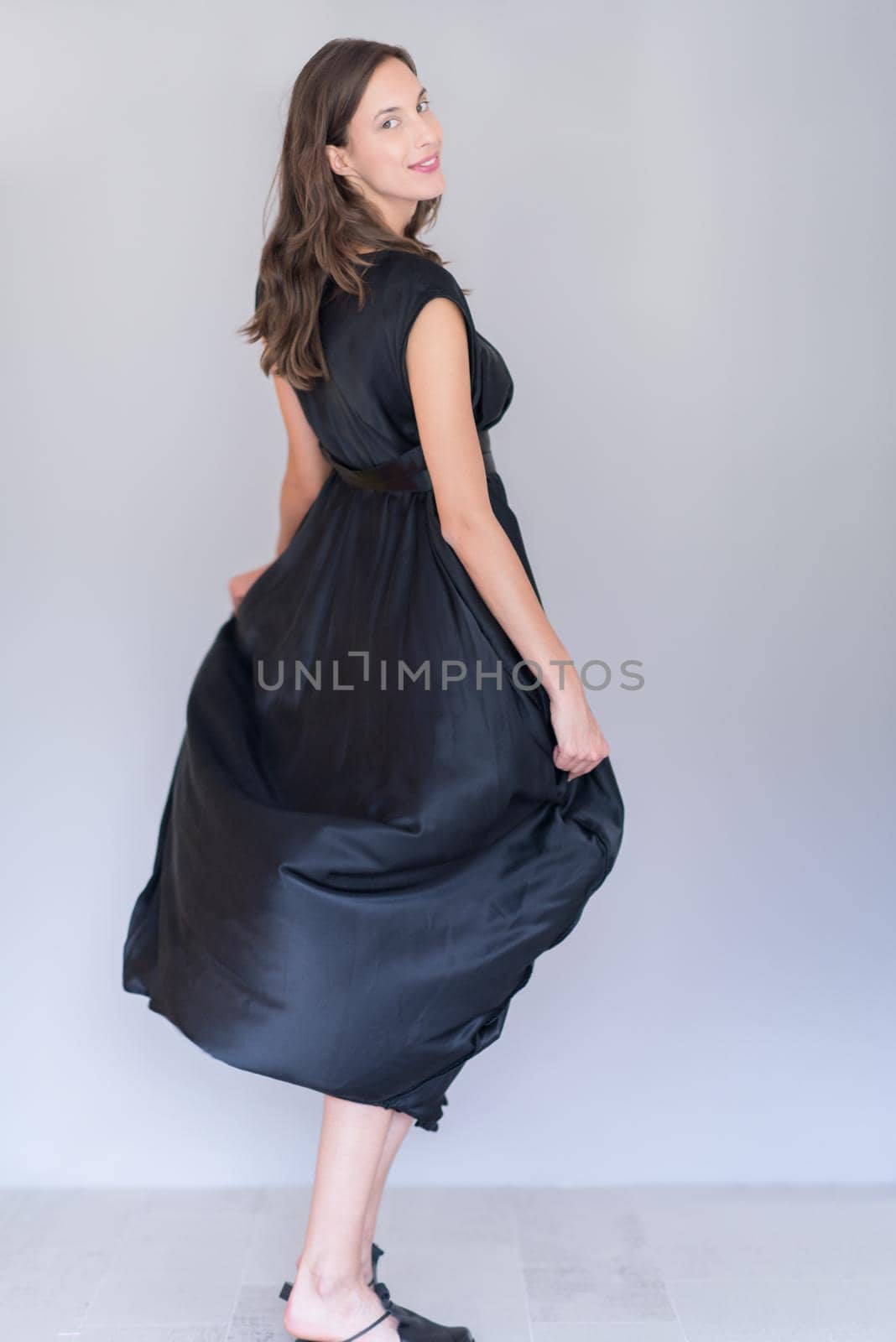 portrait of Beautiful young woman wearing a black dress isolated on white background