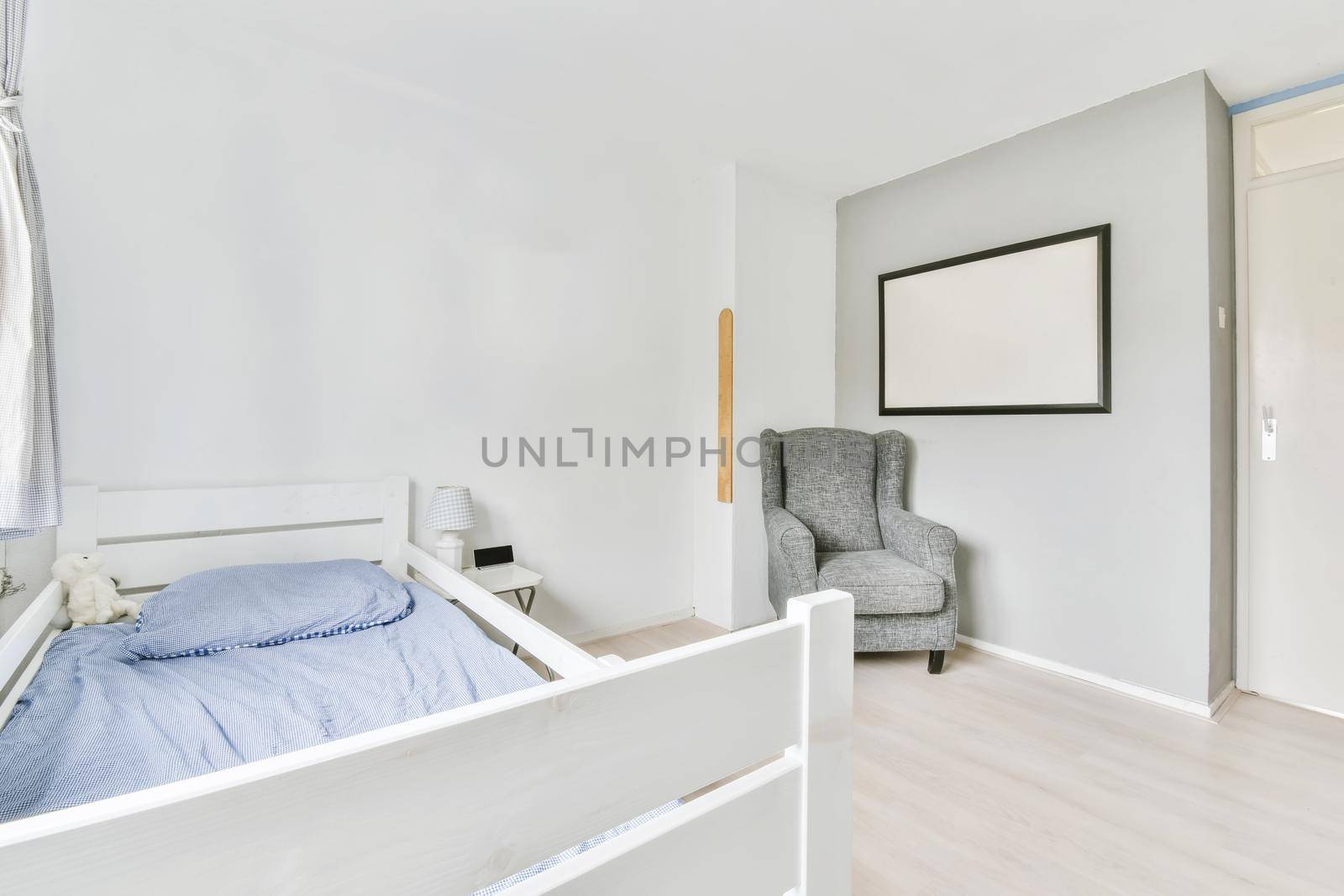 Single soft bed in the bedroom with parquet floor