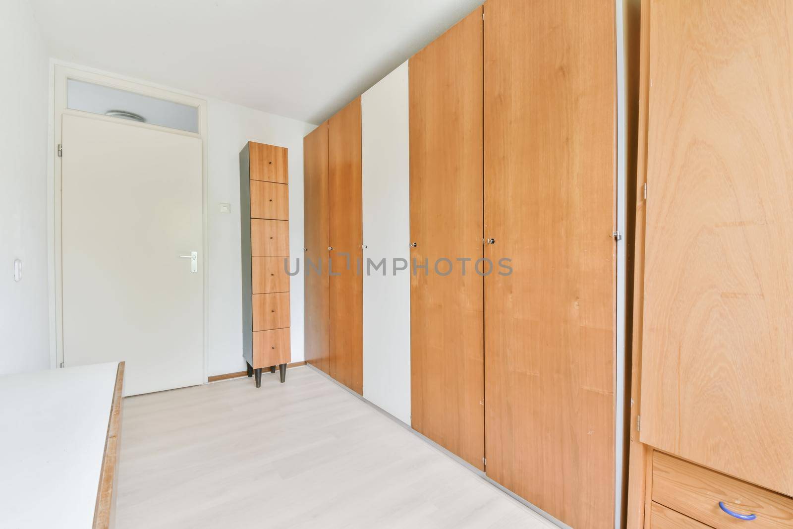 Long room with a full-length wooden wardrobe