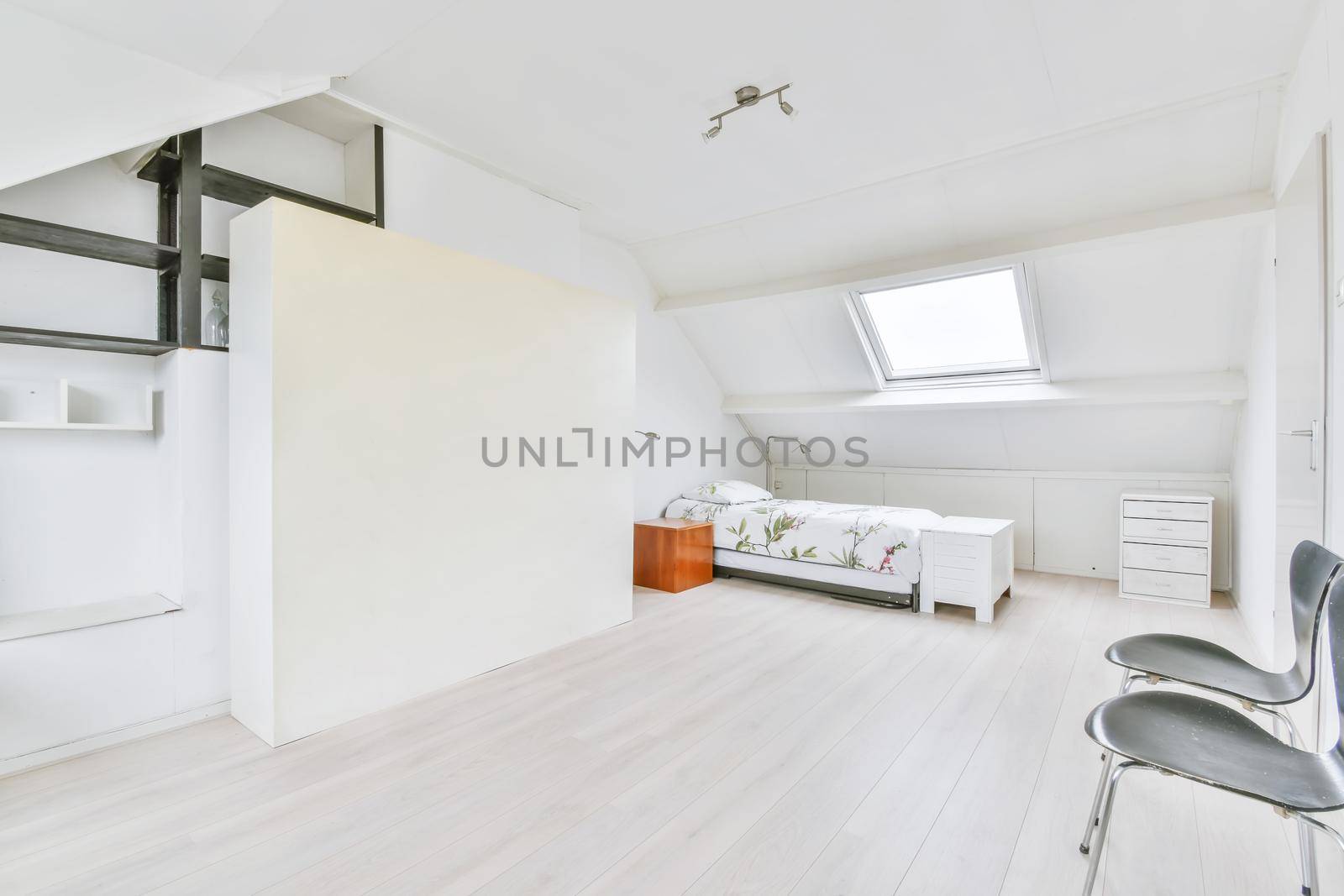 Single soft bed in the bedroom with parquet floor
