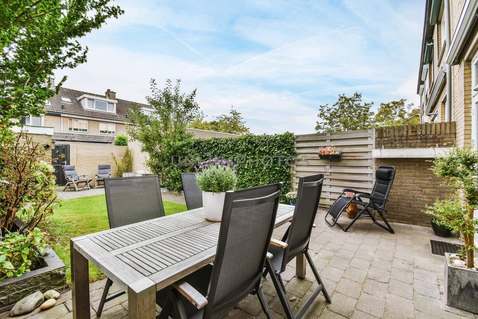 House courtyard with a chic table and comfortable chairs
