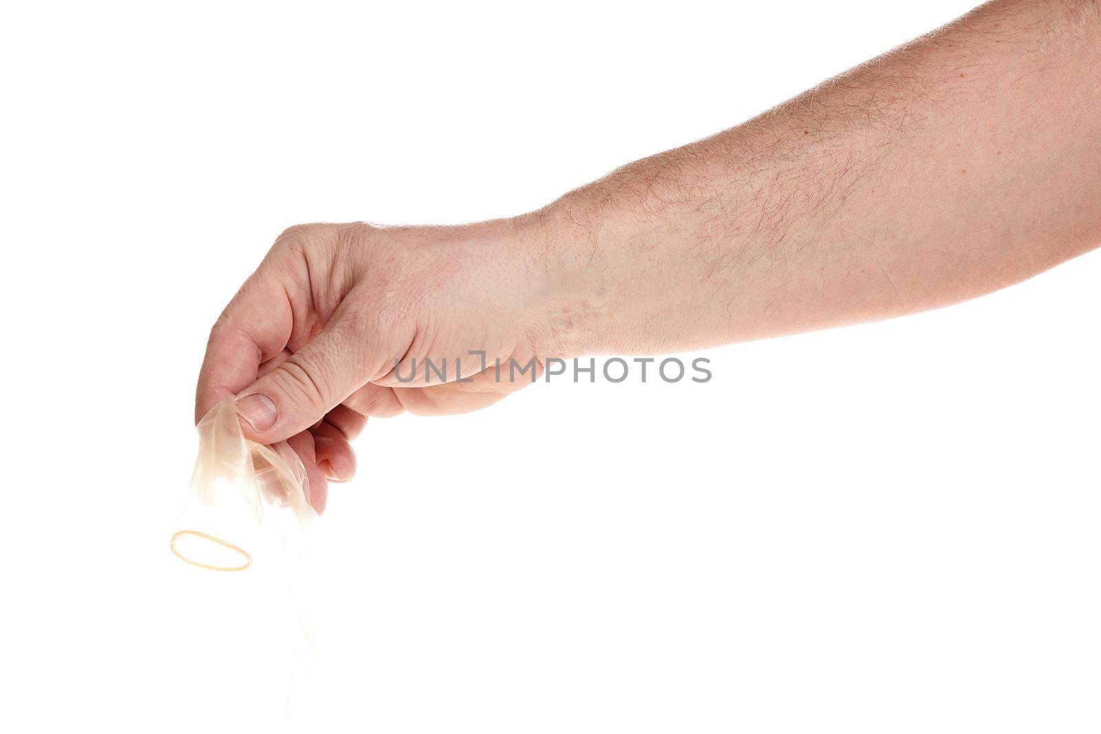 Hand holds a condom on a white background, a template for designers. Close up