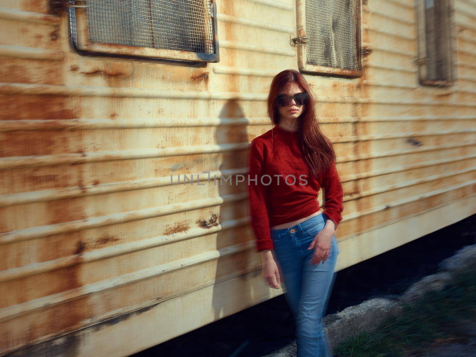 woman on near rusty trailer in the street posing. High quality photo