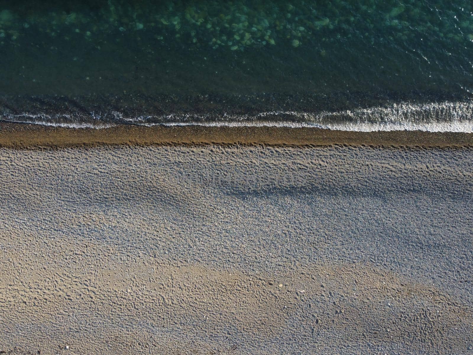 Aerial panoramic view of beautiful sunset above sea. Beautiful seascape. Sun glare, small waves on the water surface. Evening. Horizon. Nobody. No people. Copy space. Never-ending beauty of nature