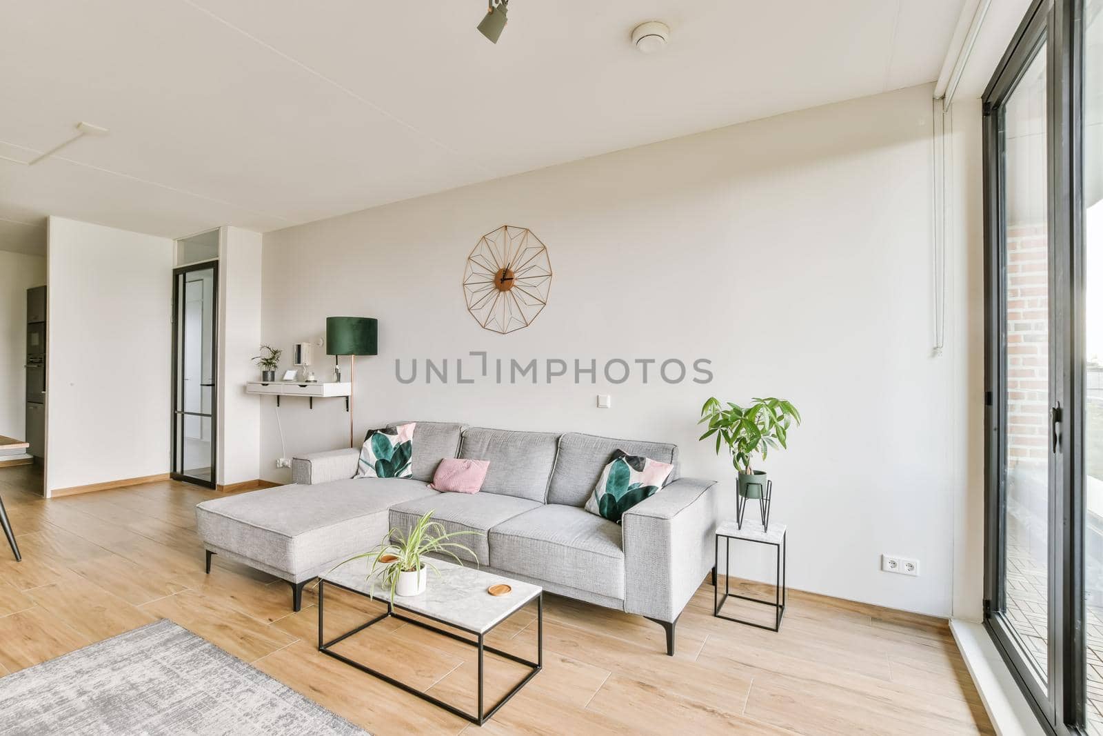 Stunning living area with gray plush sofa and glass coffee table