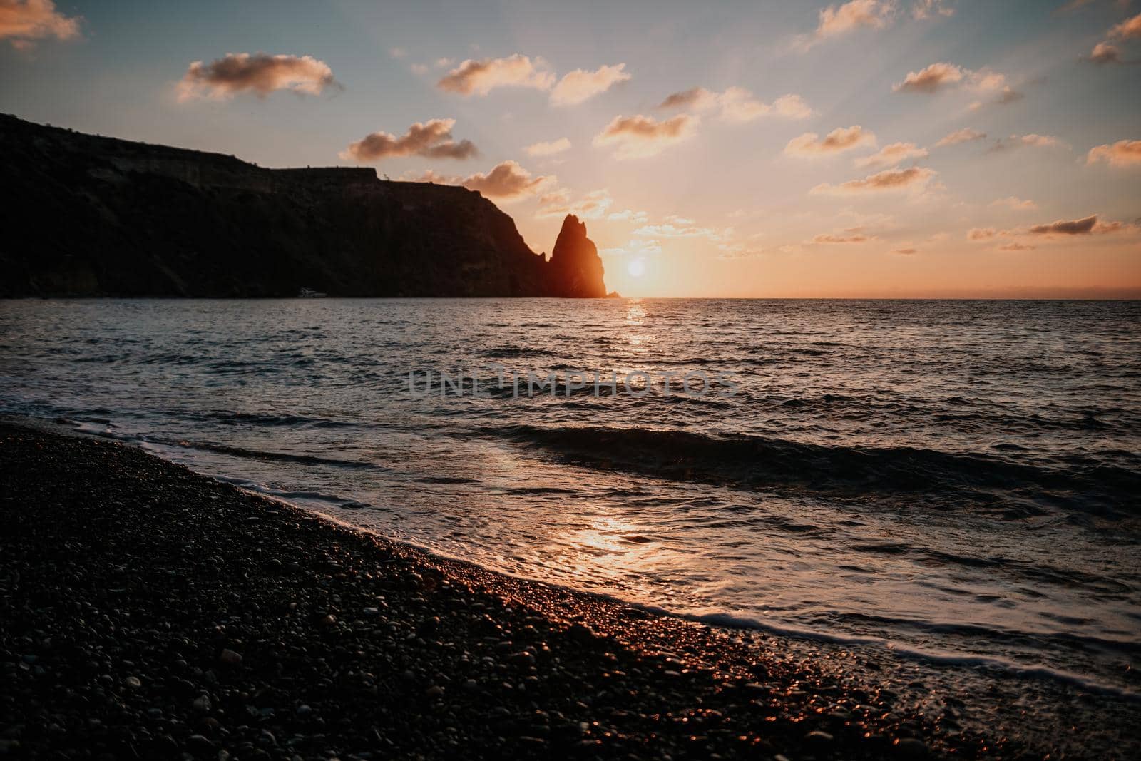 Aerial panoramic view of beautiful sunset above sea. Beautiful seascape. Sun glare, small waves on the water surface. Evening. Horizon. Nobody. No people. Copy space. Never-ending beauty of nature