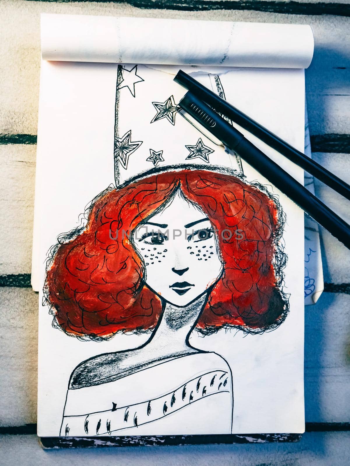 Painting concept. Drawing of a red-haired girl. Bishkek, Kyrgyzstan - March 12, 2017.