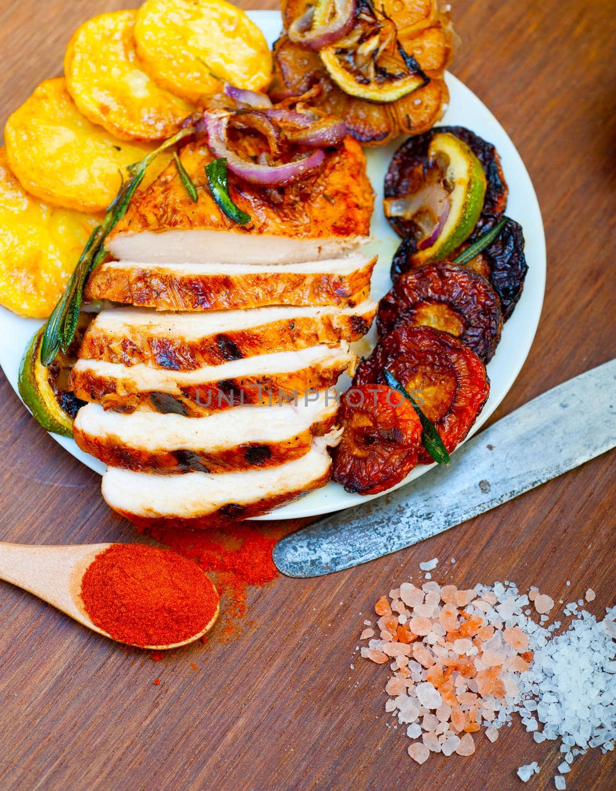 roasted grilled BBQ chicken breast with herbs and spices rustic style